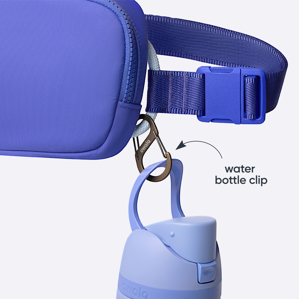Owala Daily Crossbody in Al Fresco, light blue textured pouch clipped to a matching blue FreeSip bottle with metal Owala carabiner, with text overlay reading "water bottle clip"
