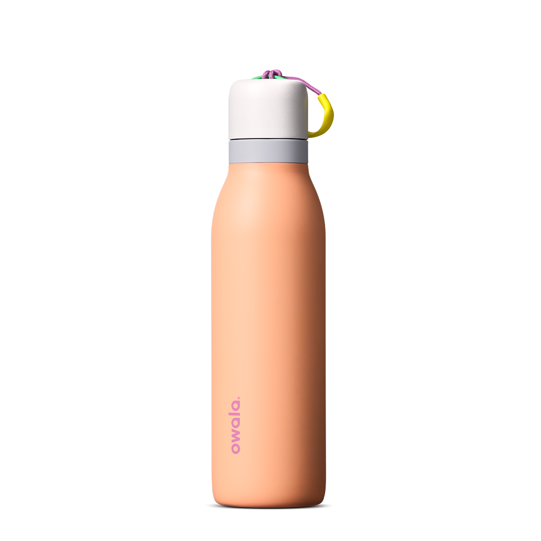 FreeSip Twist 24oz in Peachy Keen (soft coral-peach) with a light grey lid and multicolor loop accent, shown